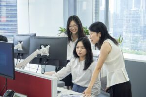 Smith Employees around Computer